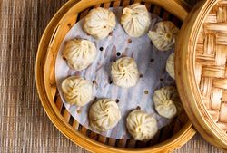 Freshly cooked dumplings inside of bamboo steamer