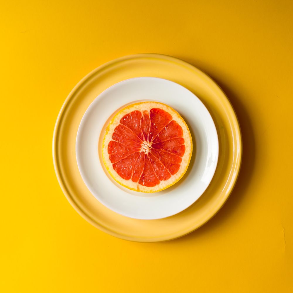 Red grapefruit slice on plate