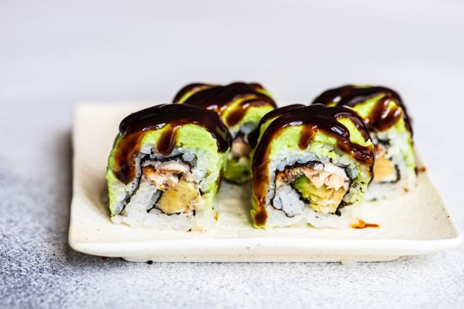 Sushi rolls with avocado and eel sauce