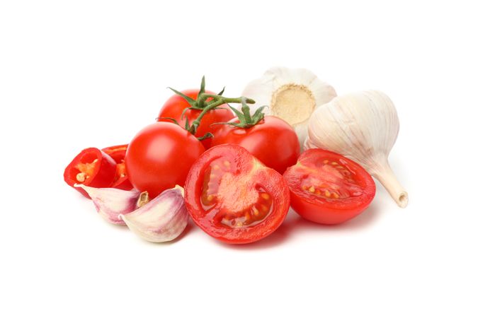 Tomatoes and garlic isolated on neutral background