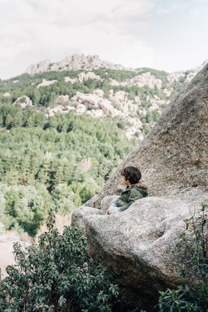 Boy walking on rocky hill
