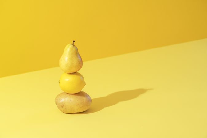 Yellow fruits and vegetables, isolated on a colored background