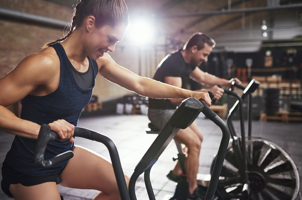 Fit couple taking exercise class together at indoor gym