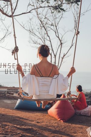 Young woman sitting on swing