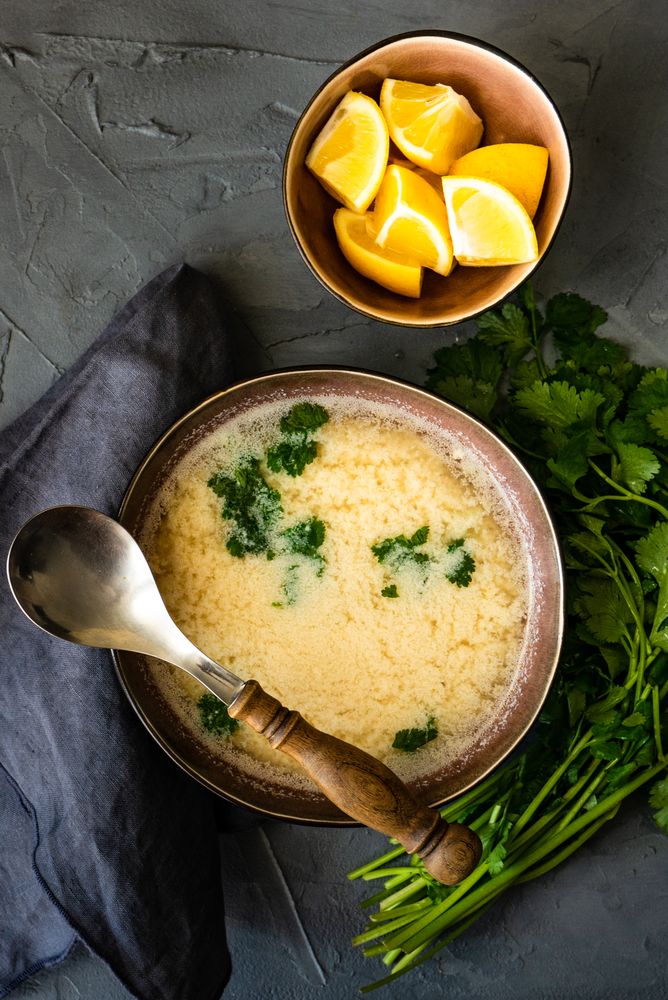 Top view French onion cream soup served with lemon