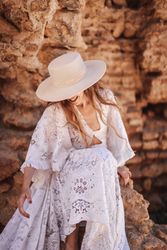 female sitting by ruined wall