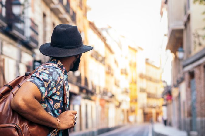 Stylish Black man walking on the city street