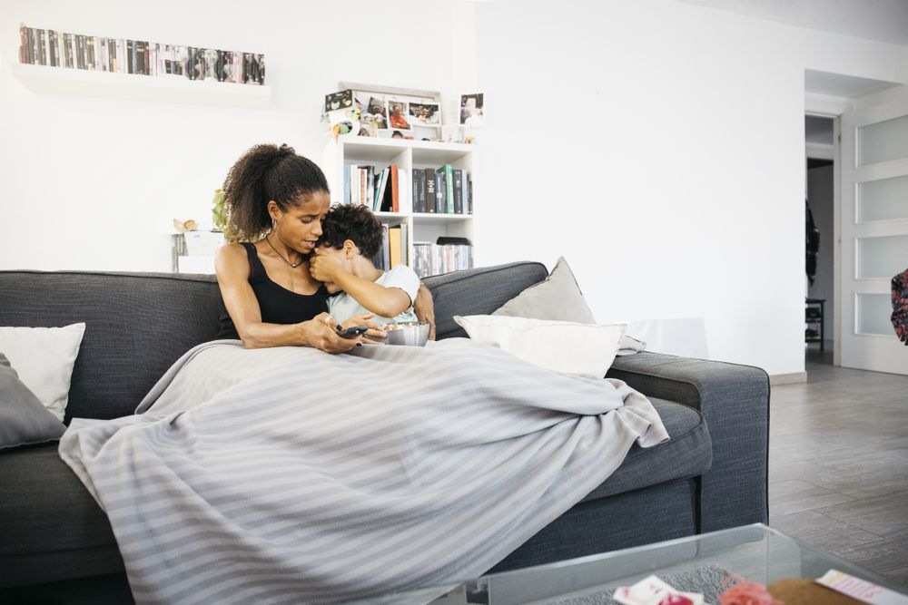 Mother and daughter watching tv at home