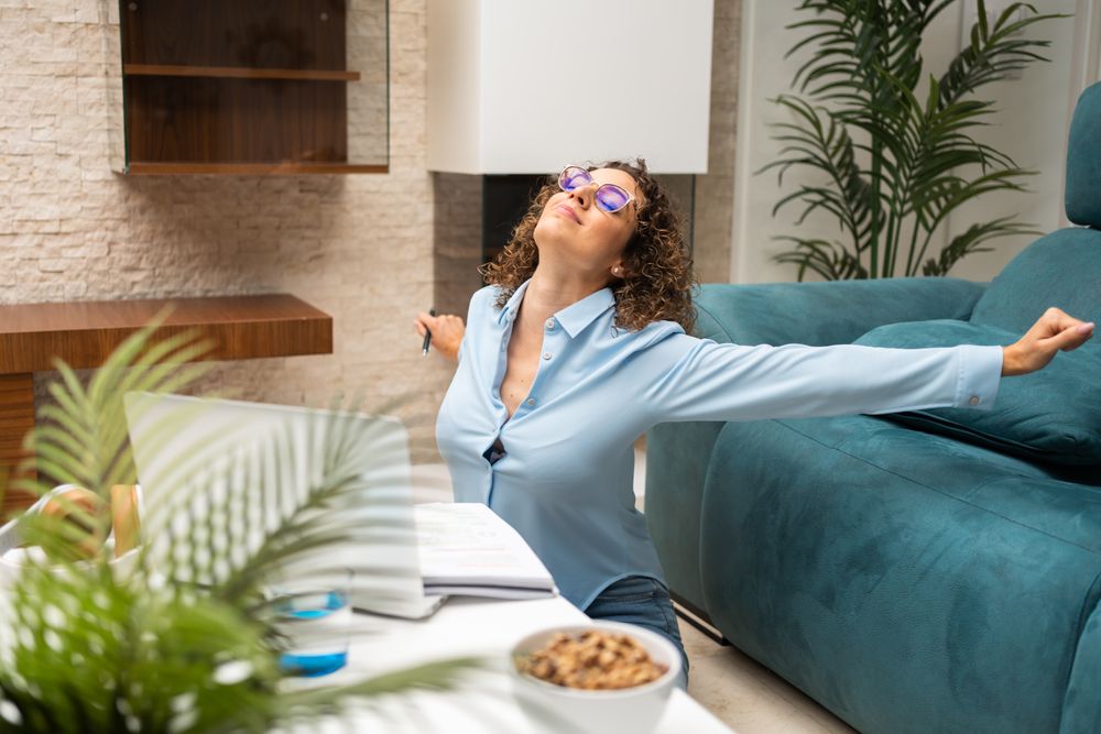 Woman stretching while working from home