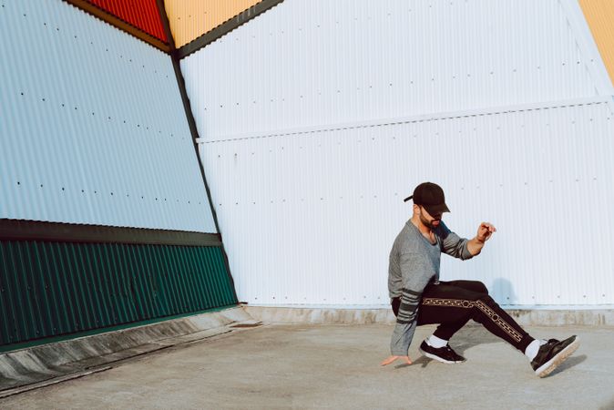 Man performing handstand near wall