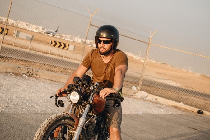Strong man driving motorcycle
