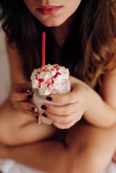 Woman holding glass with tasty drink