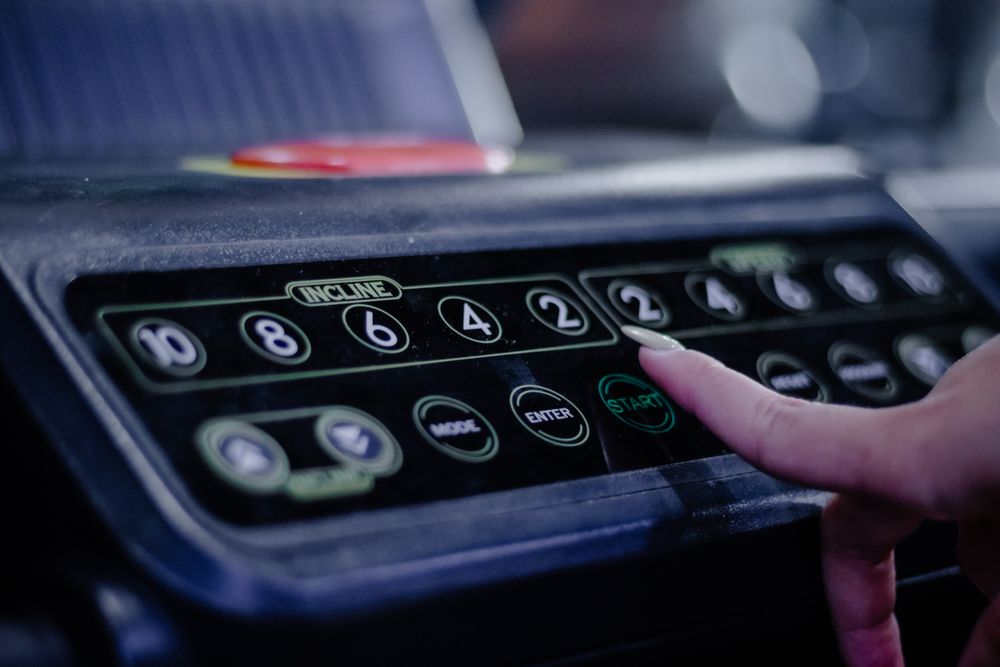Activating Treadmill: Person Pressing Start Button for Training