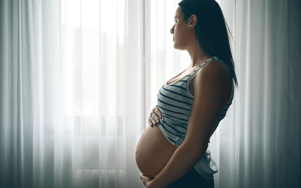 Pregnant caressing her belly