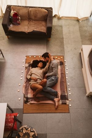 Multiethnic couple kissing on floor