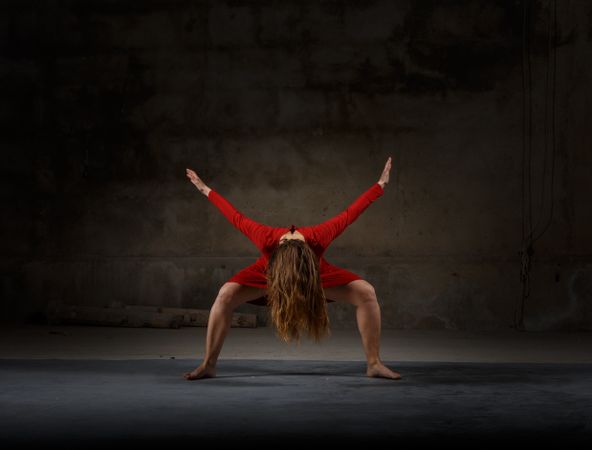 Young woman dancing in darkness