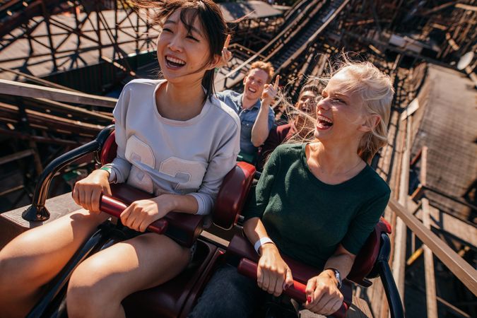 Smiling young women on rollercoaster