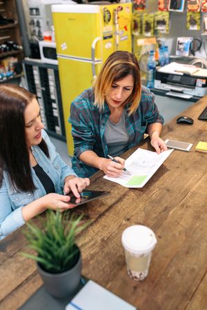 Women entrepreneur reviewing the balance with expense and cost of small business.