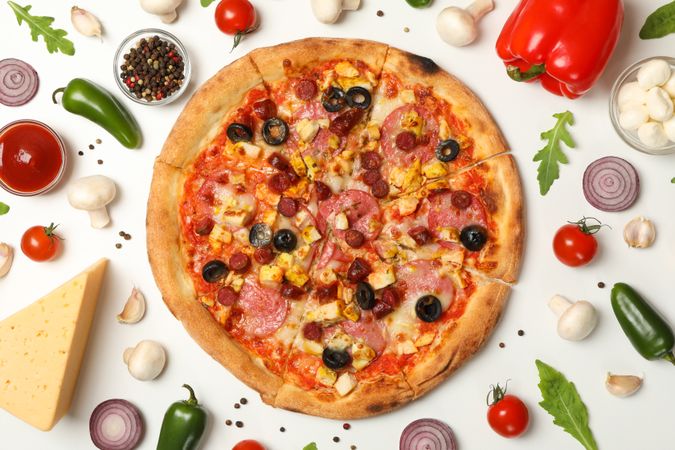 Pizza with meat and ingredients on neutral background