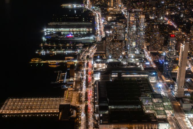 Aerial View of New York City. Helicopter Photo of a Highway Next to Docks in New York City. Panoramic View with Traffic Around a Big City with Skyscrapers in the Background