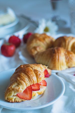 Warm homemade croissants with fresh fruit