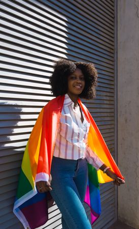 Female posing happily with the LGBT flag
