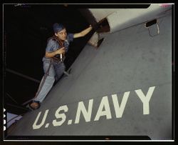 Corpus Christi, TX, USA - 1942: Woman scaling a plane at a Naval Air Base
