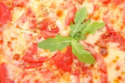 Tasty pizza with tomato on whole background, close up