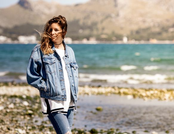 Young woman walking on seashore