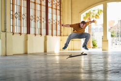 Young man doing an ollie flip on his skateboard