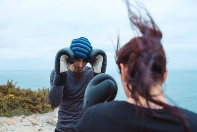 Boxers exercising on cliff