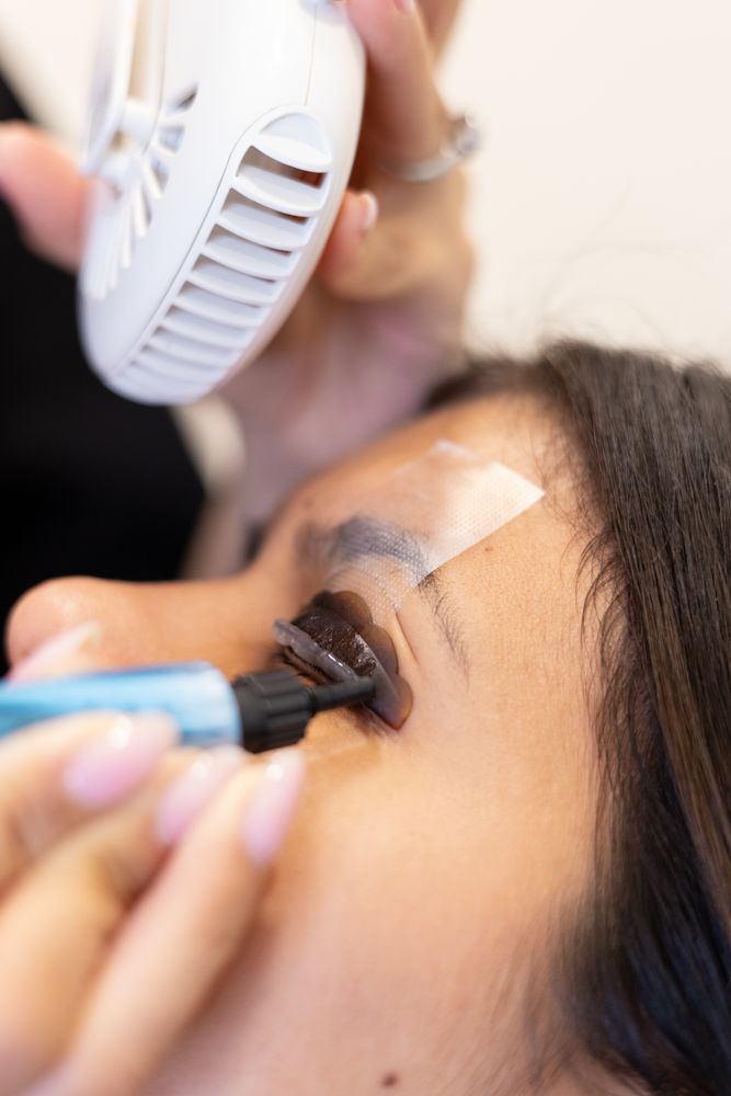 Beautician making eyelash lamination and dyeing procedures