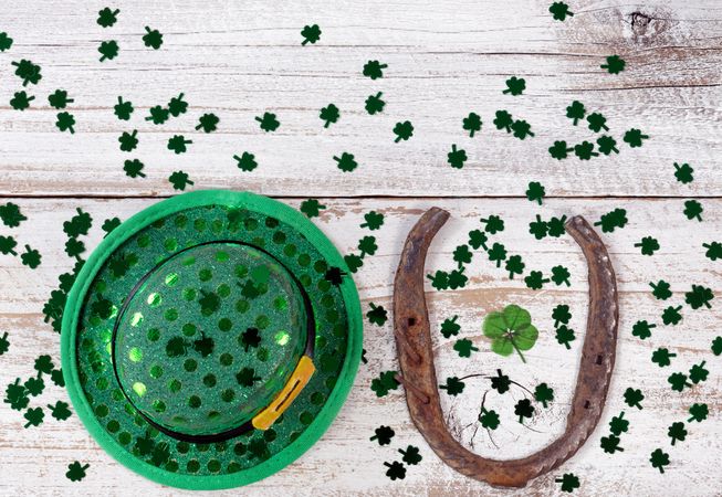 Lucky St Patrick Day with traditional items on rustic white wood background