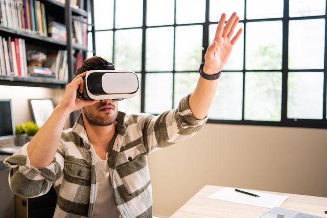 Male in bright modern office in VR headset