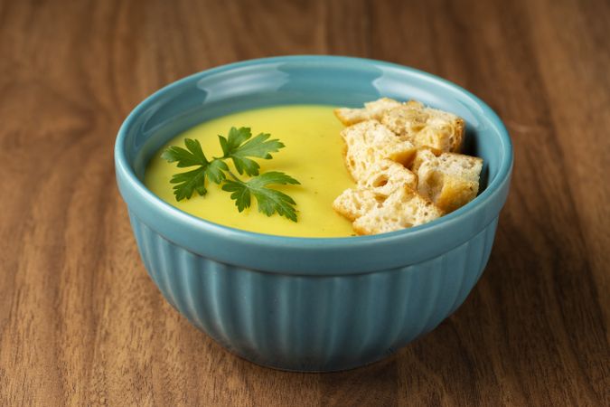 Bowl with onion soup and croutons on the table.