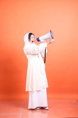 Empowered Voice, Young woman proclaims with vigor through a mega