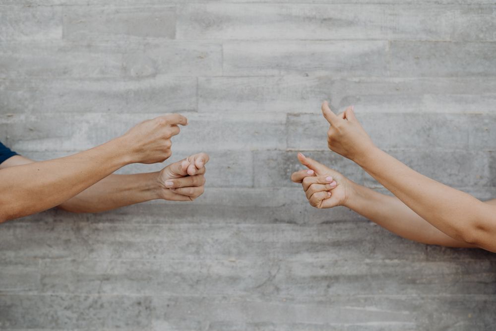 Hands gesturing music on background of grey wall
