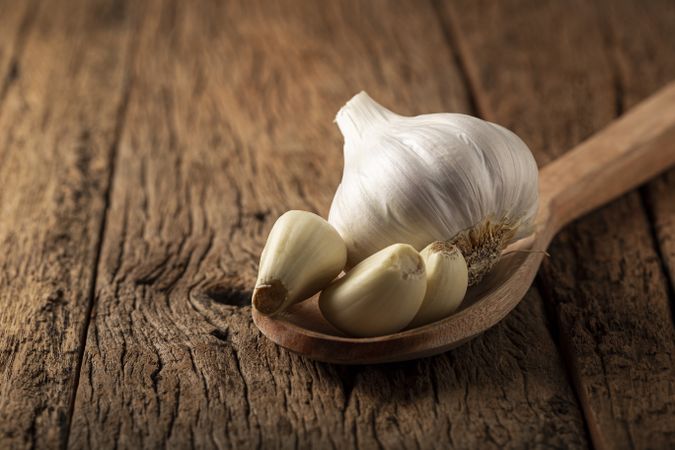 Garlic bulb and garlic cloves on the wooden table.