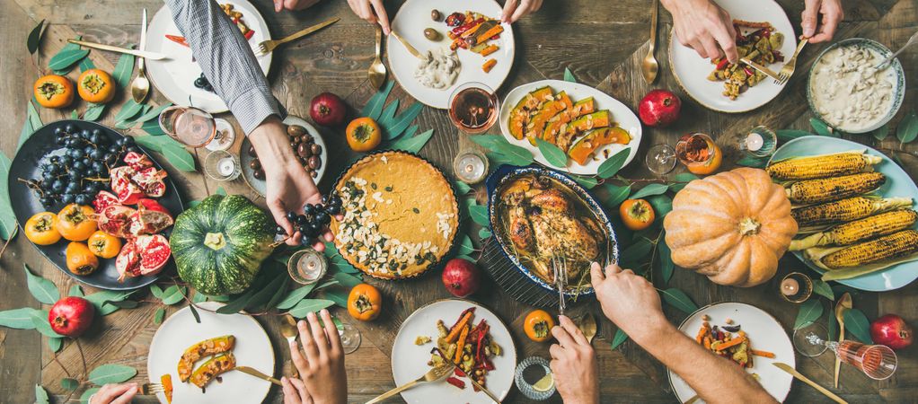 Flat-lay of friends feasting at Thanksgiving Day table