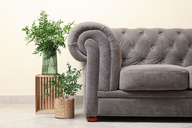 Simple interior with sofa against light beige wall