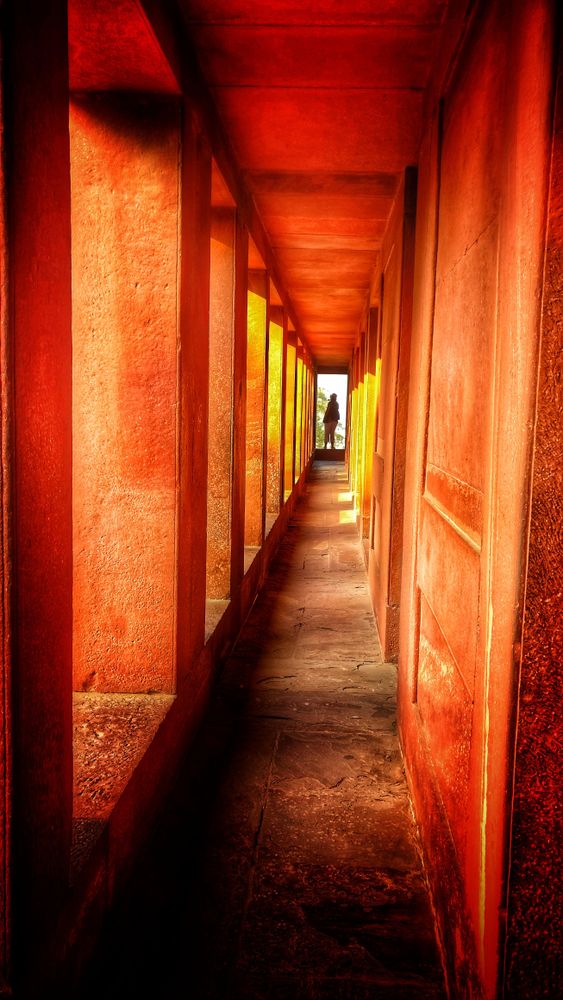 Person standing at the end of hall