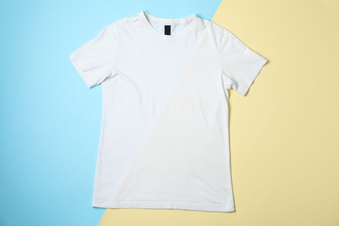 Blank t-shirt on two tone background, space for text