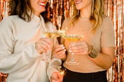 Crop women proposing toast during party