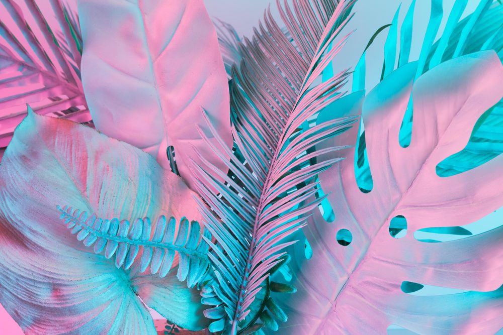 Tropical and palm leaves in vibrant bold gradient holographic colors