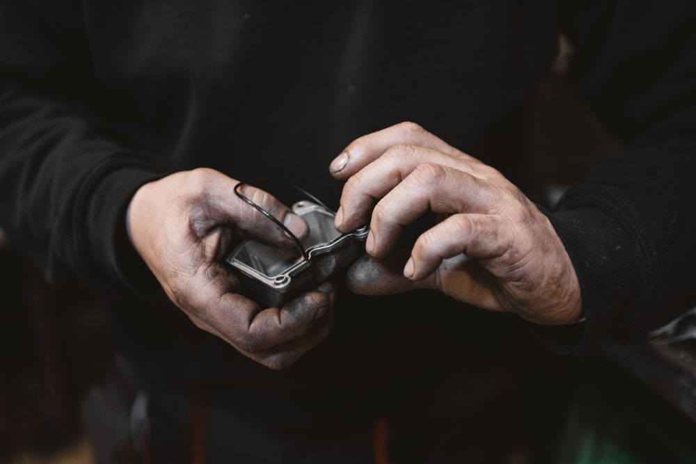 Crop man repairing detail