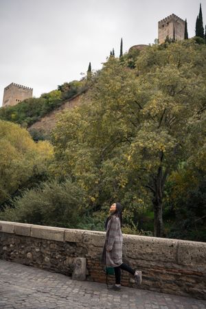 Female tourist enjoying view of big old castle