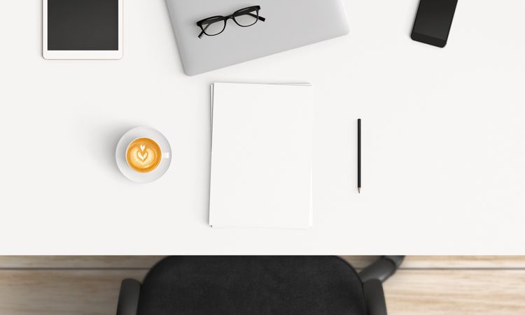 Modern workplace with laptop, coffee cup and smartphone or tablet copy space on table background. Top view. Flat lay style.