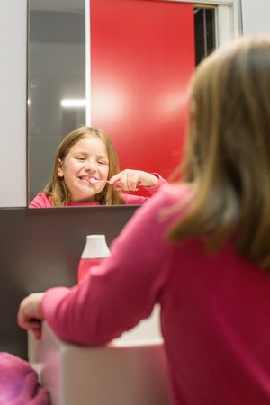 Cute girl brushing her teeth