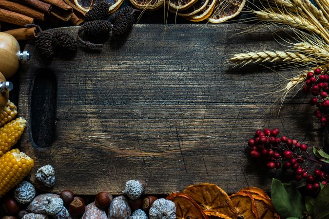 Top view of wooden table with seasonal nuts, berries, vegetable and fruits for fall season