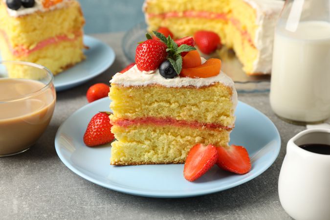 Composition with delicious berry cream cake on gray background. Tasty dessert